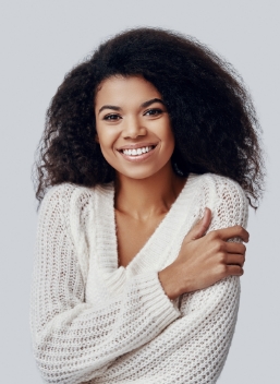 Smiling young woman in white sweater