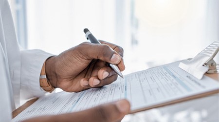 a patient filling out forms at a dental office