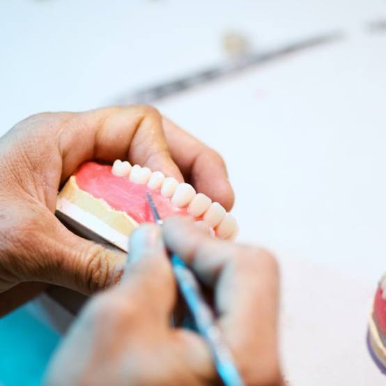 a person working on constructing new dentures